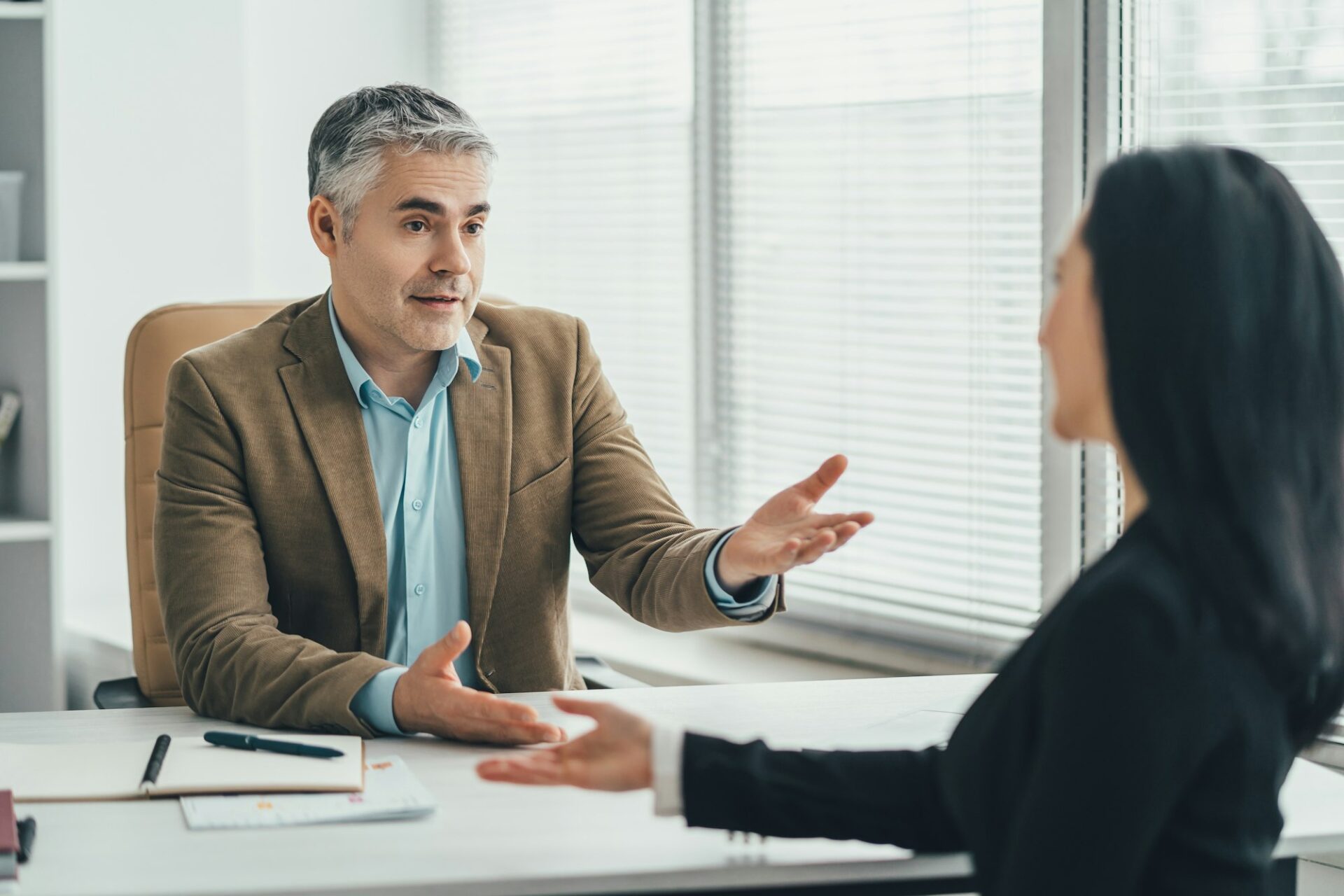 The two business people talking at the office table